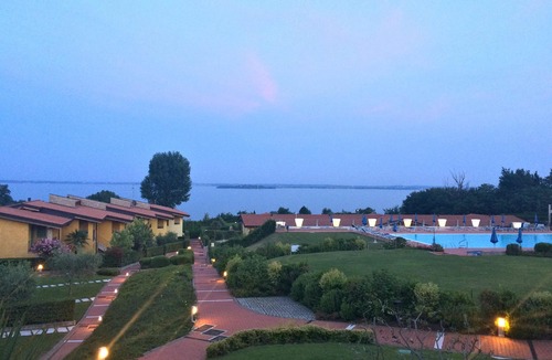 Solarolo Apartment | Stunning three-room lake view in a residence with three swimming pools and 36,000 m2 of greenery